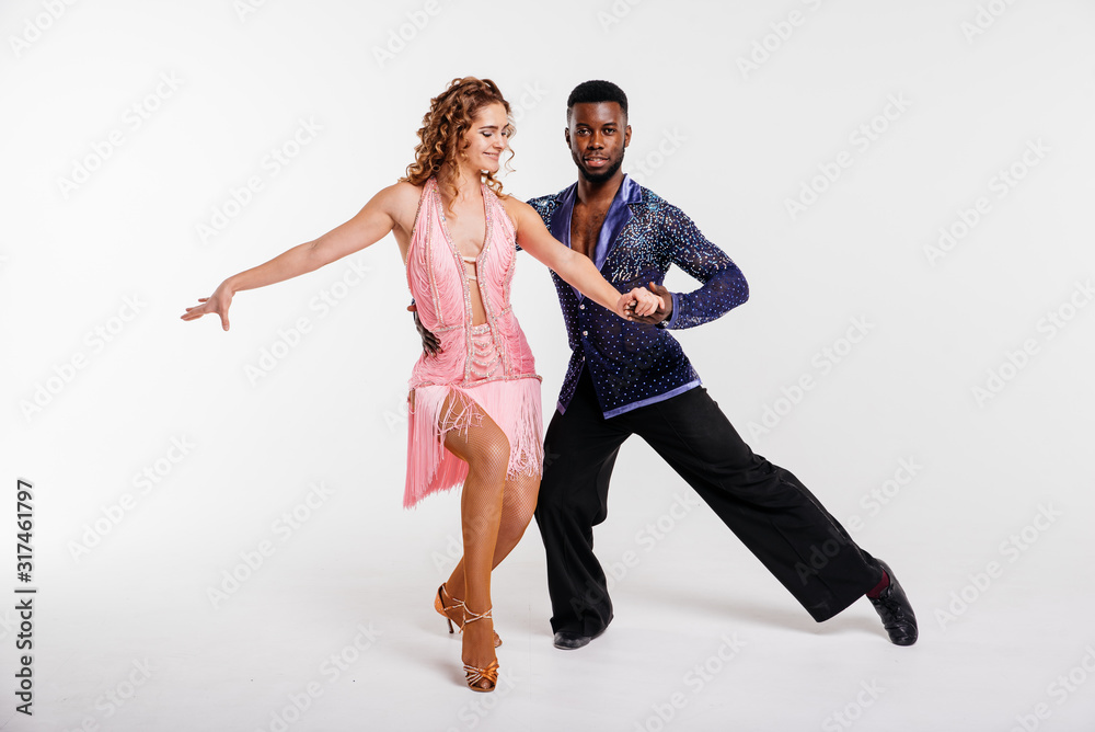Black man and white woman dancing couple, fitness concept. Dancers on a white background Black man and white woman dancing couple, fitness concept. Dancers on a white background