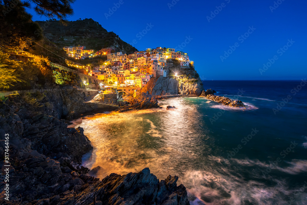 Panoramic night view of Manarola - one of five famous colorful villages of Cinque Terre National Park in Italy, Liguria region.
