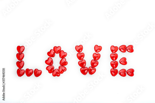 Word love with colored beads on white background