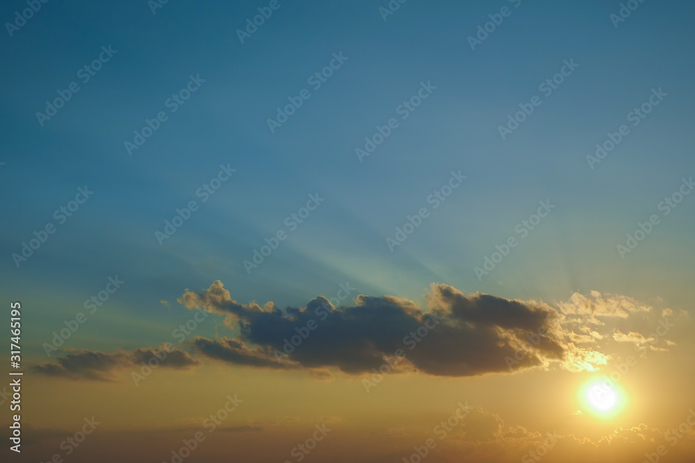 light rays of sun above clear blue sky