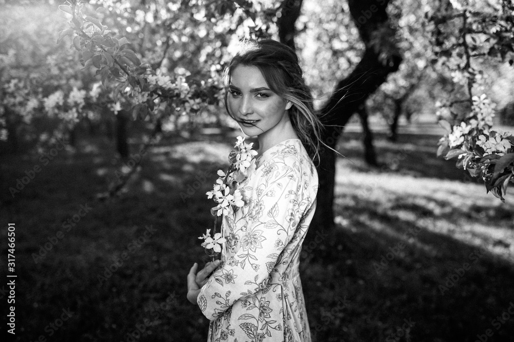 beautiful young brunette woman standing near the apple tree on a warm summer day beautiful young brunette woman standing near the apple tree on a warm summer day
