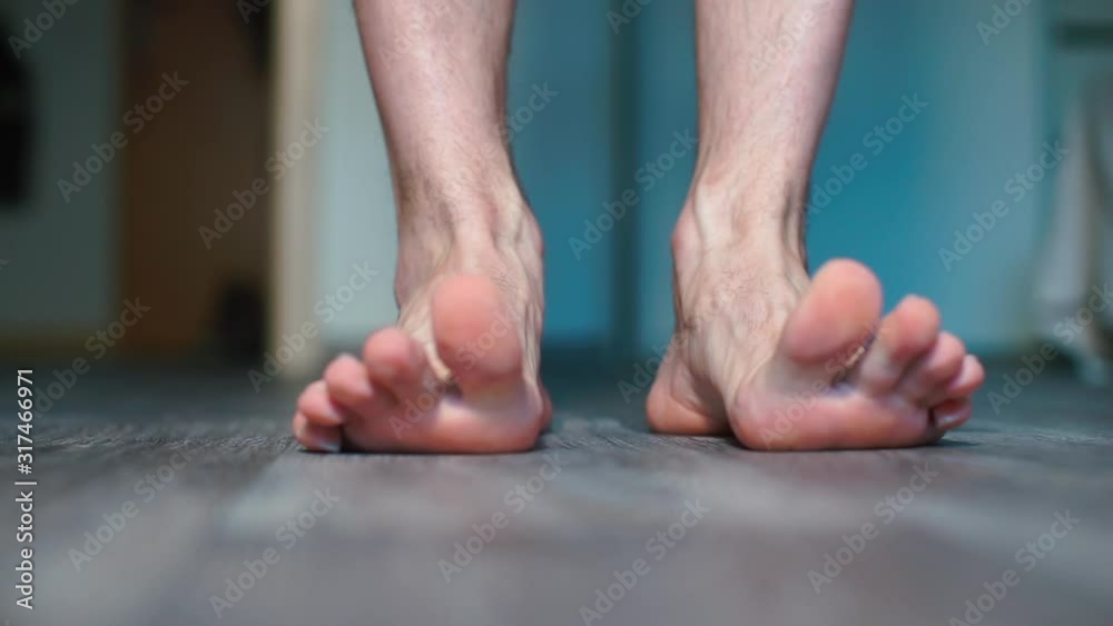 Close-up of male feet standing on the floor. Close-up of male feet standing on the floor.