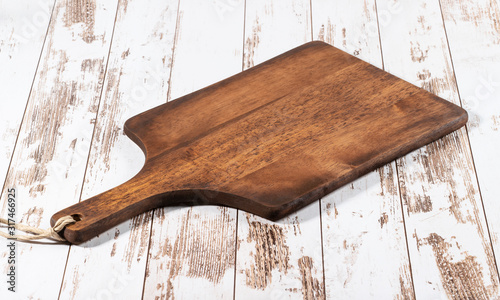 Cutting board on a wooden white kitchen table.