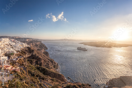 Old Town Thira on the Santorini island, famous churches against colorful sunset in Greece