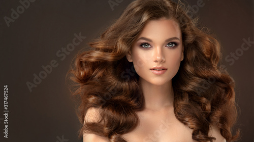 Beauty brunette girl with long  and   shiny wavy black hair .  Beautiful   wo...