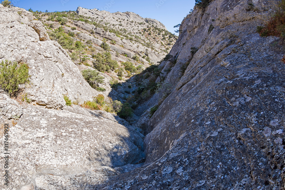 Riverbed pierced in the stone by rain and melt water. Crimean mountains. Riverbed pierced in the stone by rain and melt water. Crimean mountains.