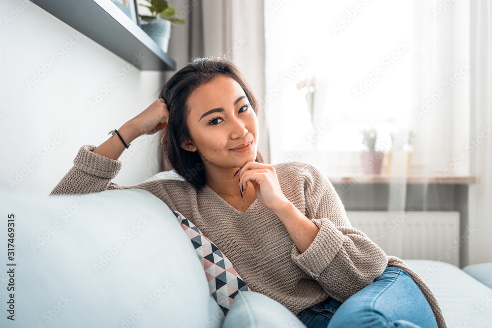 Asian girl at home deep in thoughts thinking and planning Asian girl at home deep in thoughts thinking and planning
