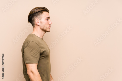 Young caucasian man posing isolated gazing left, sideways pose.