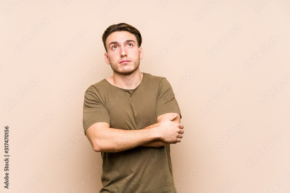 Young caucasian man posing isolated tired of a repetitive task. Young caucasian man posing isolated tired of a repetitive task.