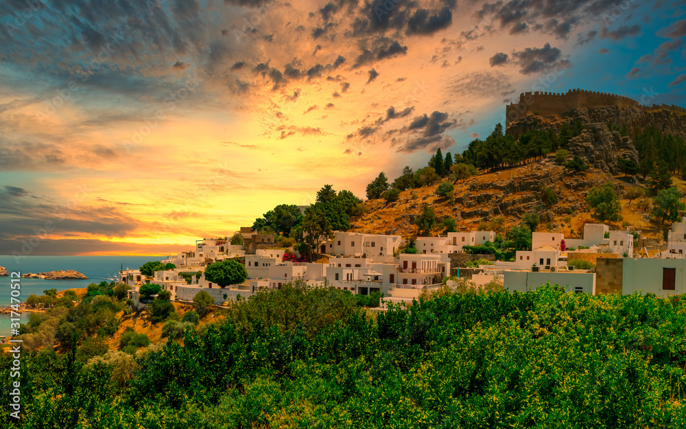 The historic city of Lindos and the Acropolis of Lindos on Rhodes at sunset, Greece