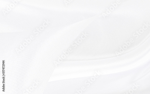 White gray satin texture that is white silver fabric silk background with beautiful soft blur pattern natural.