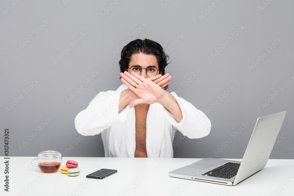 Young handsome man working after a shower doing a denial gesture Young handsome man working after a shower doing a denial gesture