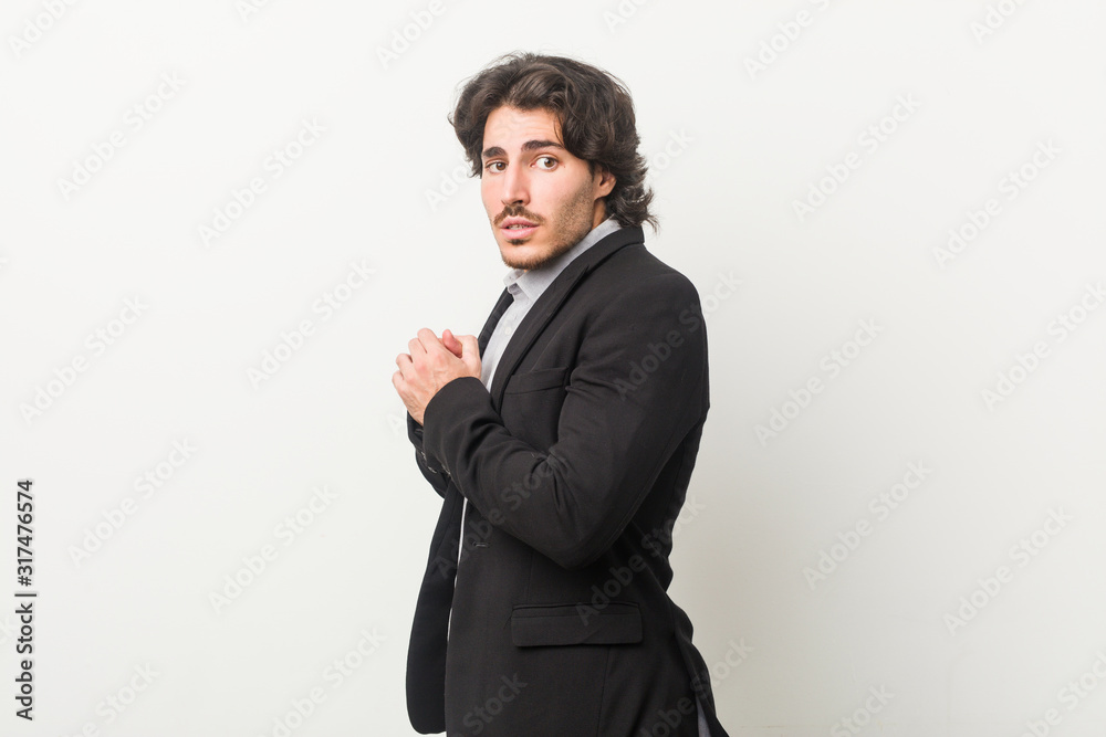 Young business man against a white background scared and afraid. Young business man against a white background scared and afraid.