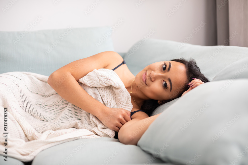 Relaxed asian young woman laying in bed at home Relaxed asian young woman laying in bed at home