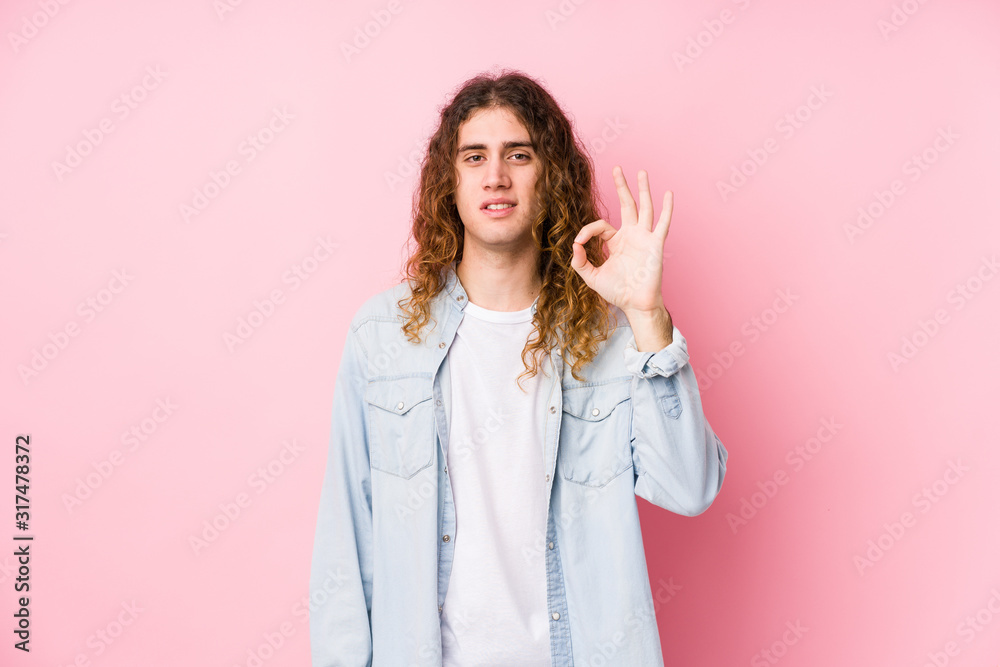 Long hair man posing isolated cheerful and confident showing ok gesture. Long hair man posing isolated cheerful and confident showing ok gesture.