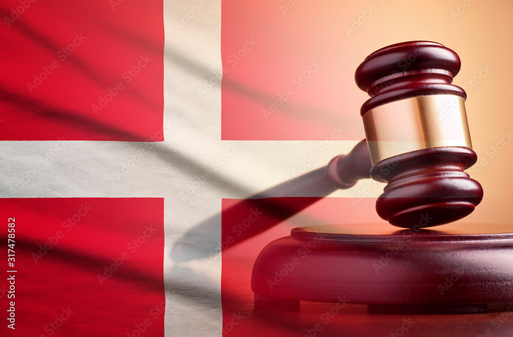 Lawyers wooden gavel over the flag of Denmark