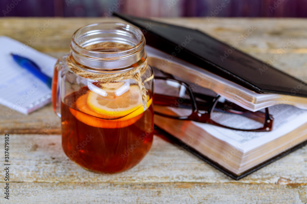Book, glasses and tea with lemon on table. Book, glasses and tea with lemon on table.