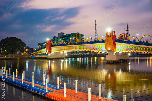 A photo of Brendeng Bridge (Jembatan Brendeng) across Cisadane River in Tangerang, Banten; at sunset. photo