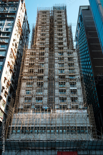 Canvas Print Bamboo scaffolding on building facade, bamboo pole framework