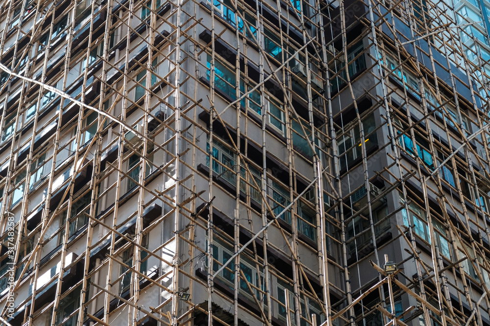 Bamboo scaffolding on building facade, bamboo pole framework