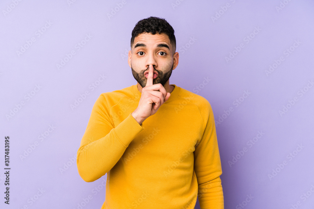 Young mixed race arabic man isolated keeping a secret or asking for silence. Young mixed race arabic man isolated keeping a secret or asking for silence.