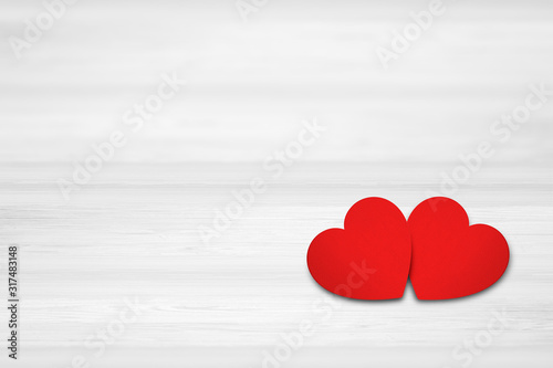 Two hearts on white wood background. Valentines Day concept.