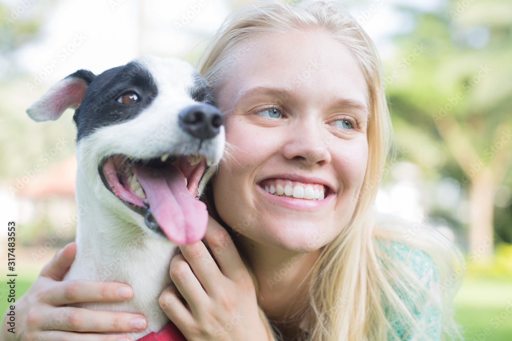 Woman hugging her dog a hug. Dog love and friendship. Woman hugging her dog a hug. Dog love and friendship.