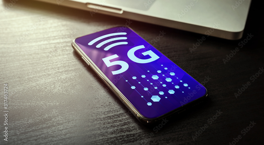 Obraz premium 5G Network Technology - High Speed Wireless Systems Concept with smartphone and laptop on the background. 5g symbol and abstract cubes symbolizing a quick transfer of information on the phone screen
