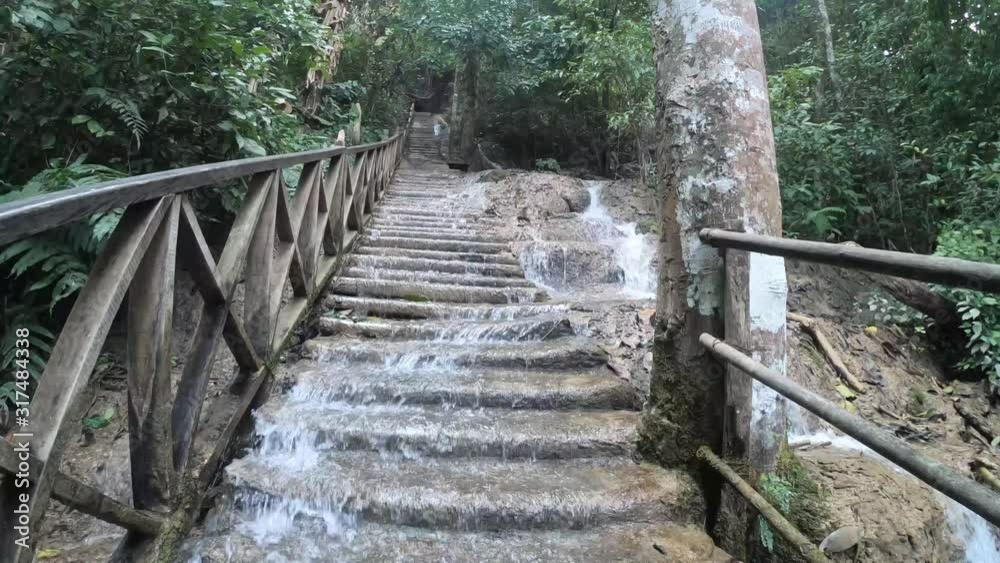 Water rushing over a staircase trail at Kuang Si waterfalls, Luang Prabang, Laos Water rushing over a staircase trail at Kuang Si waterfalls, Luang Prabang, Laos