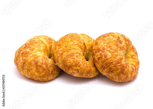 Studio shot three fresh baked French butter croissant isolated on white