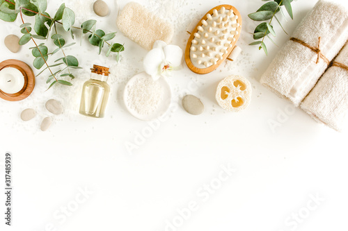 Spa concept with eucalyptus oil and eucalyptus leaf extract natural /organic spa cosmetics products, eco friendly bathroom accessories. Skincare concept on white background. Flat lay composition 
