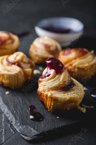 Small puff pastry rolls with cherry jam