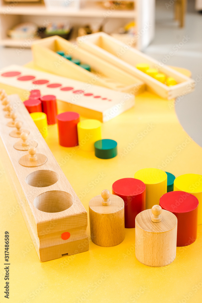Selective focus of wooden games on yellow desk in school Selective focus of wooden games on yellow desk in school