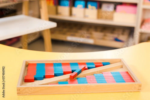 Selective focus of educational game with colored wooden blocks on desk