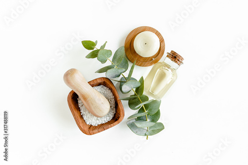 Spa Background. Natural/Organic spa cosmetics products, eco friendly bathroom accessories, eucalyptus leaves. Skincare concept on white background. Flat lay, top view