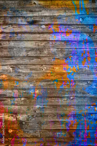 Spots of multi-colored paint on a wooden wall. Spots of multi-colored paint on a wooden wall. Abstract background for business cards and covers. 