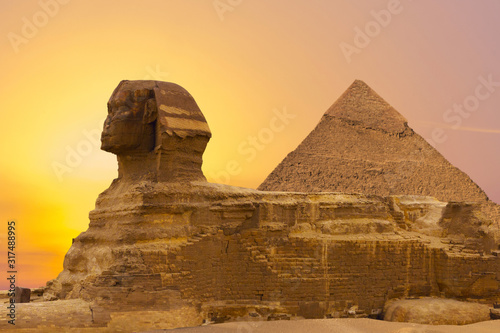 Sphinx against the backdrop of the great Egyptian pyramids. Africa  Giza Plateau.