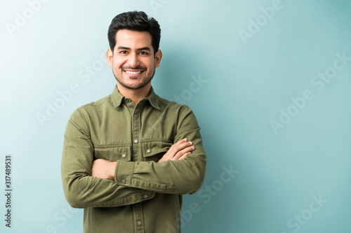 Tableau sur toile Confident Smiling Man Standing In Studio