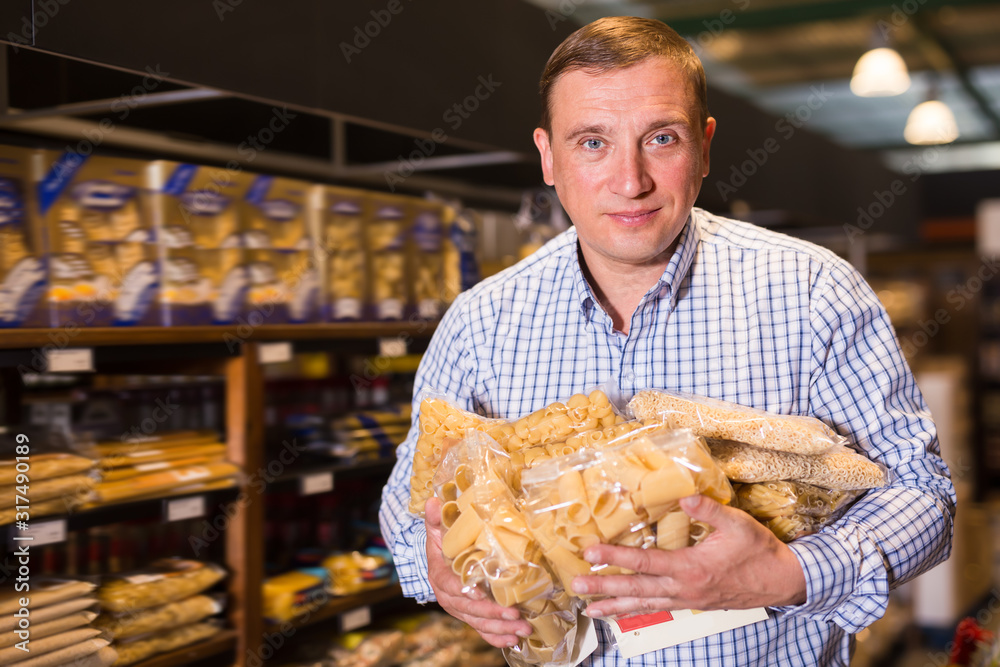 Portrait of adult man buying pasta