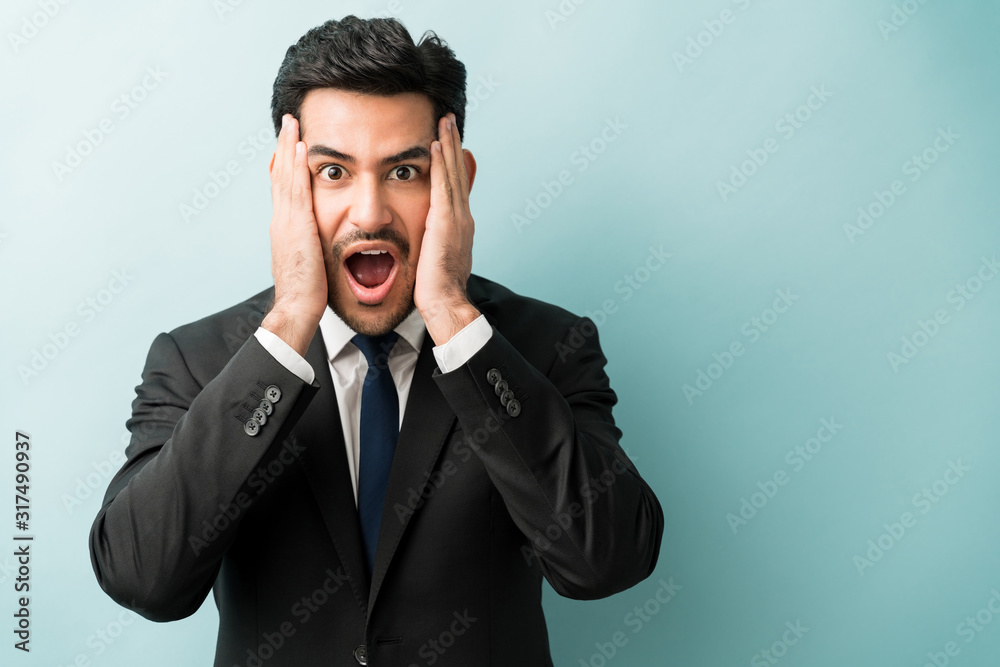 Handsome Hispanic Executive Standing With Mouth Open Handsome Hispanic Executive Standing With Mouth Open
