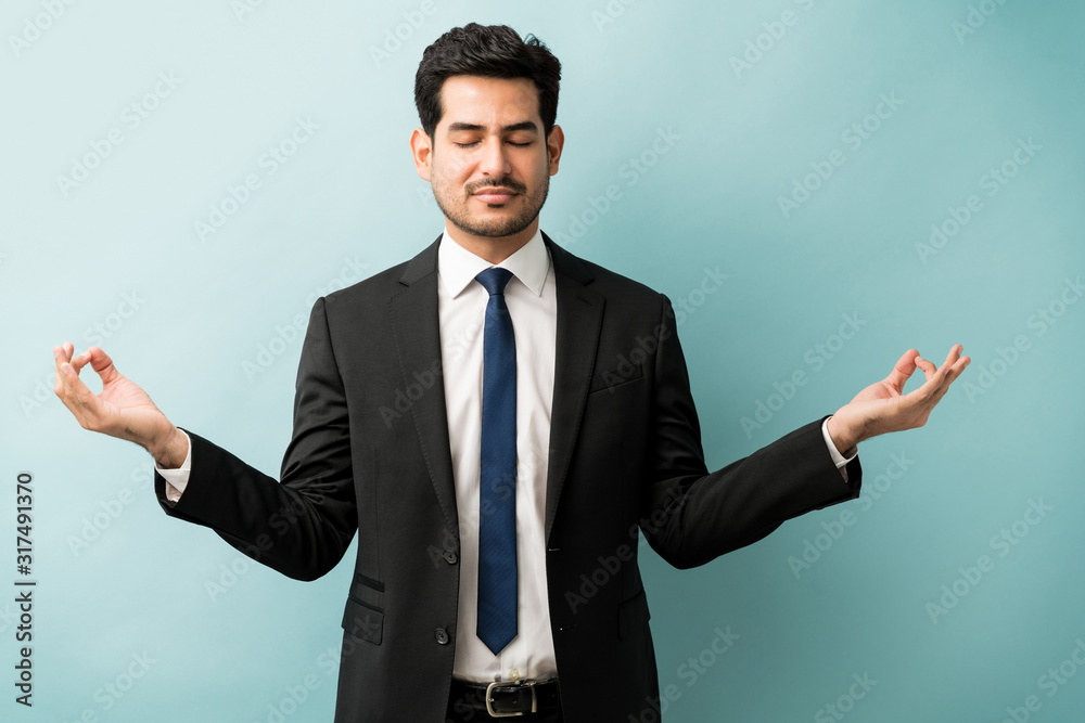 Calm Businessman Performing Meditation In Studio Calm Businessman Performing Meditation In Studio
