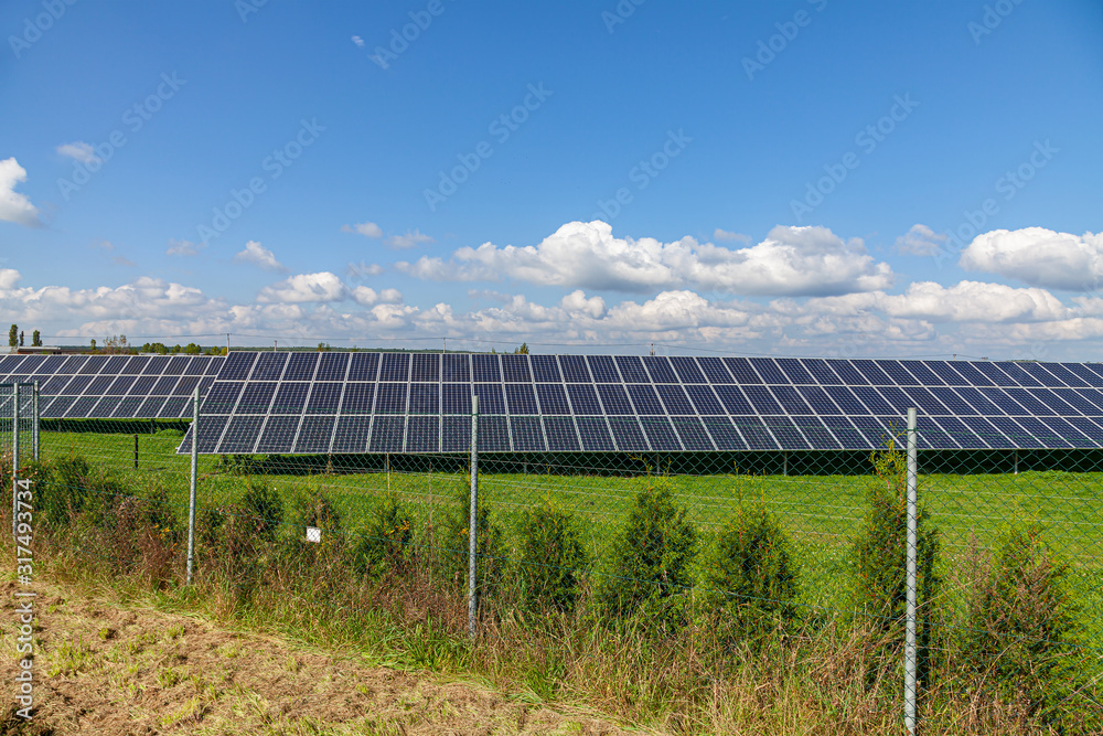 Solar energy panels on green field, blue sky Solar energy panels on green field, blue sky