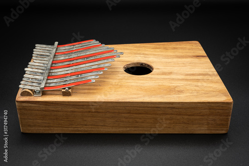 Thumb piano (Kalimba, Mbira) with silver and red tines photo