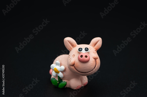 Figurine of a small piggy with a white flower