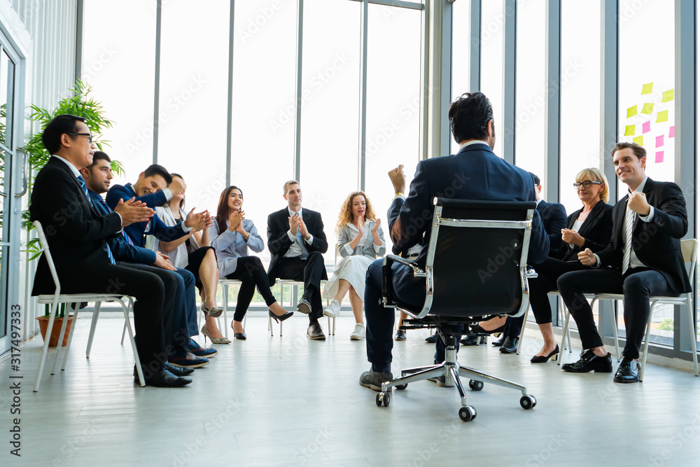 Rear view of Business colleagues discussing report at modern office. Business People applauding while in meeting at office, The Secret to successful business concept Rear view of Business colleagues discussing report at modern office. Business People applauding while in meeting at office, The Secret to successful business concept