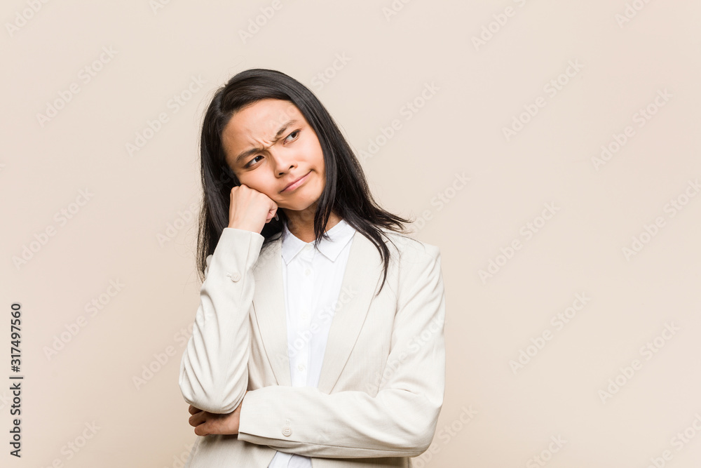 Young business chinese woman who feels sad and pensive, looking at copy space. Young business chinese woman who feels sad and pensive, looking at copy space.