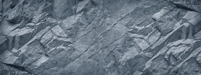 Gray grunge banner. Abstract stone background. The texture of the stone wall. Close-up. Light gray rock backdrop.