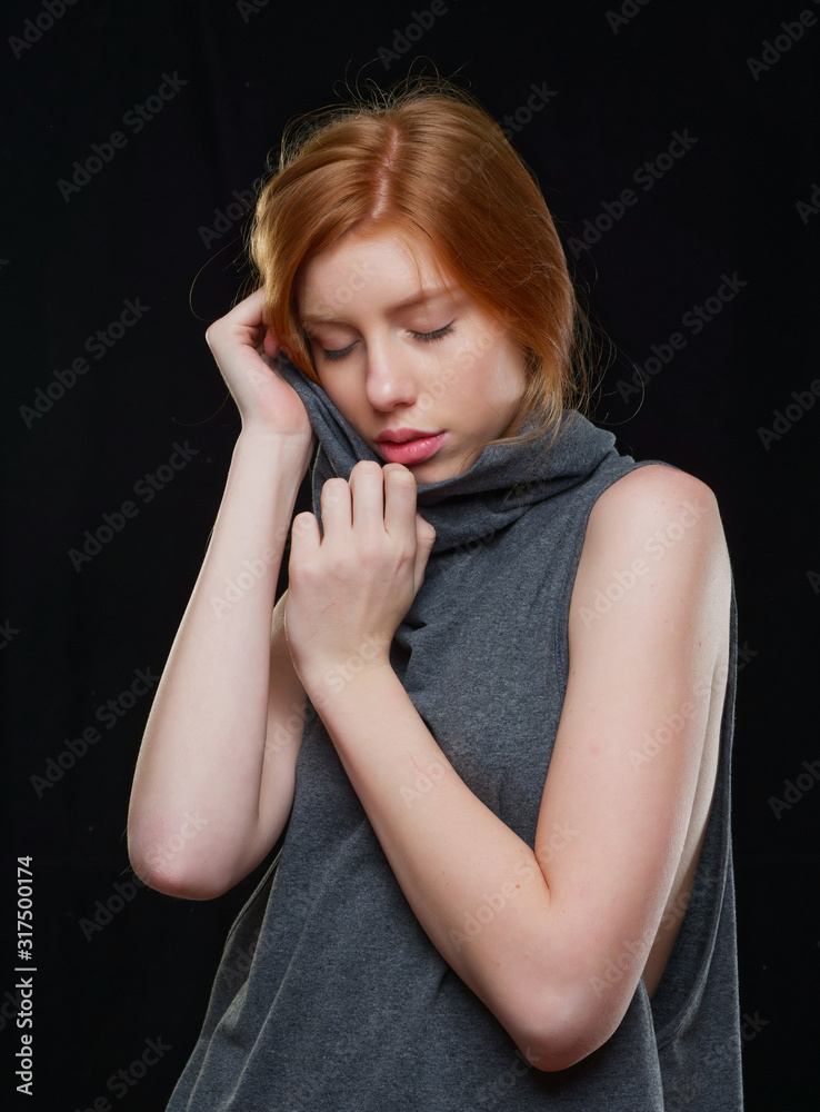 young girl with long red hair on a black background young girl with long red hair on a black background
