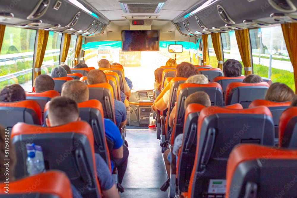 passengers riding a bus, rear view passengers riding a bus, rear view