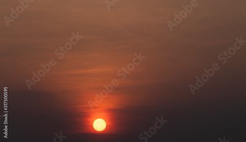 Sunset orange sky background at evening with clouds © ณรงค์พล ไชยบุตร